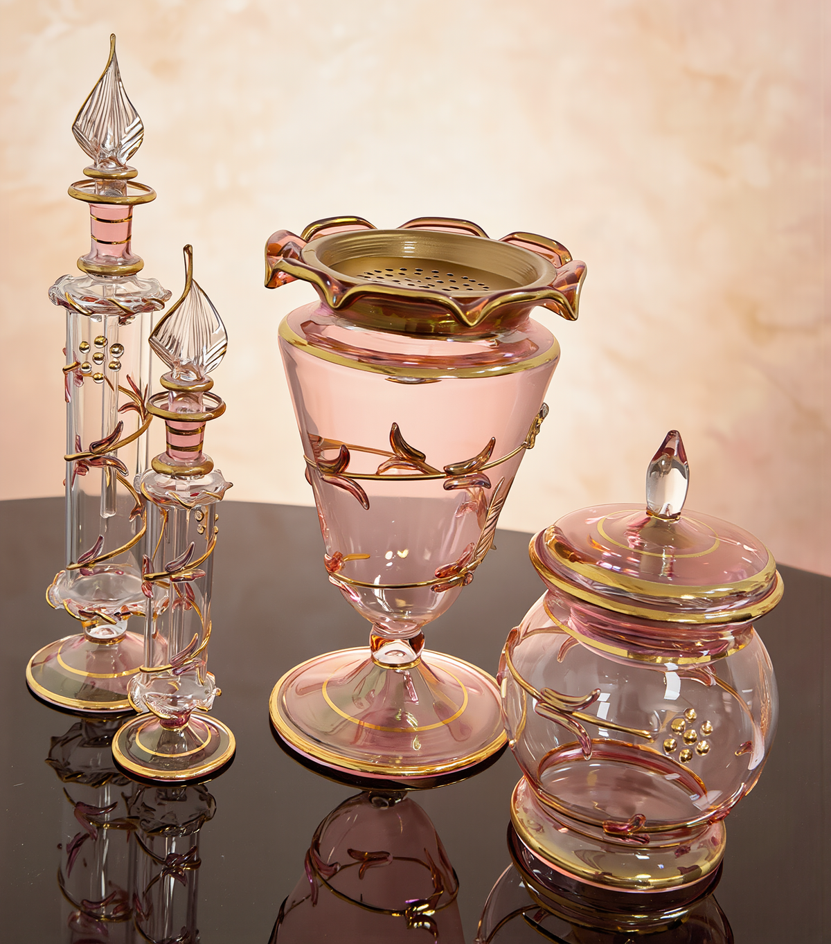 Ward Discovery Set — four-piece rose glass bakhoor set: gold-trayed mabkhara, lidded bakhoor jar and two attar bottles